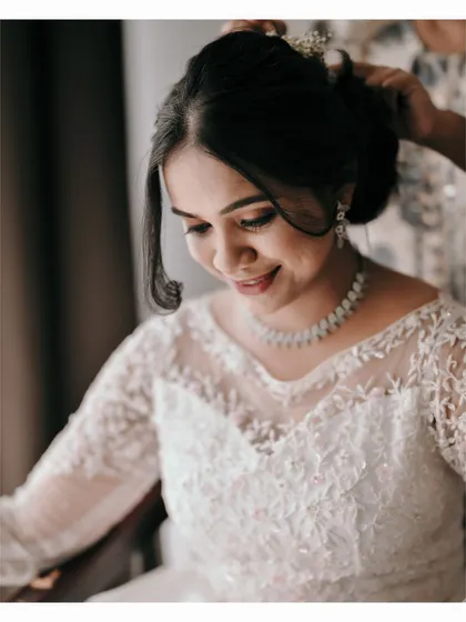 A close-up of the bride getting her hair done, a lovely behind-the-scenes moment.