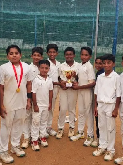 A formal team photo with the trophy after winning the Triangular Series, showcasing the unity and success of our young team.