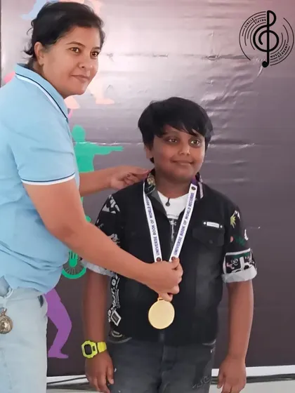 Our student Yugan proudly receives his medal at a world-record event. We encourage our students to participate in prestigious events to showcase their skills.