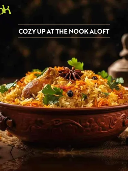 Cozy up at The Nook, Aloft, with a comforting bowl of chicken biryani. This image showcases the aromatic and flavourful Indian comfort food perfect for a relaxed meal.
