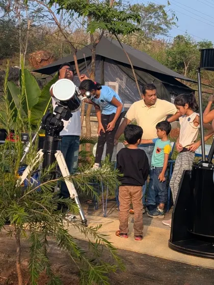 Families gather around the telescopes as dusk settles in. The excitement builds as we prepare for a night of looking up at the planets and stars.