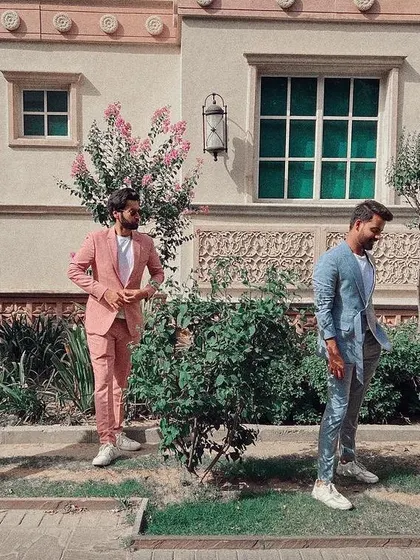 A suit should reflect your personality, whether that's classic or contemporary. Here you can see my work in a variety of styles, from a sharp light grey to a bold pink, all custom-made. These versatile pieces show how a bespoke suit can be styled for any occasion, even paired with sneakers for a modern look.
