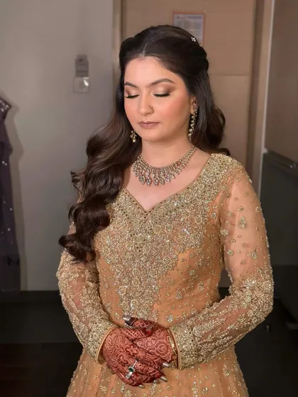 Eyes closed, you can appreciate the soft eyeshadow and the way the hairstyle frames her face. This is timeless, skin-like glam.