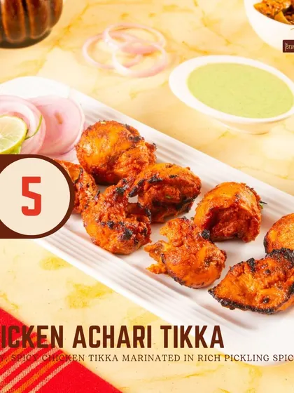The Chicken Achari Tikka is a tangy and spicy delight, marinated in rich pickling spices that give it a distinctive and mouth-watering flavor.