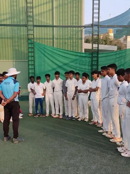 The young players listen intently during a briefing. Discipline and focus are values we instill from day one.