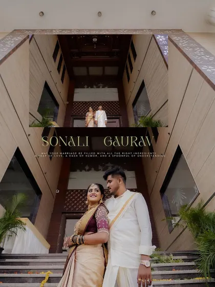 A dramatic, low-angle shot of the couple in front of a grand building, adding a sense of scale and architectural beauty to their wedding portrait.