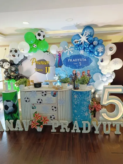 Another angle of the combined party setup, highlighting the custom backdrops and marquee numbers for each child.