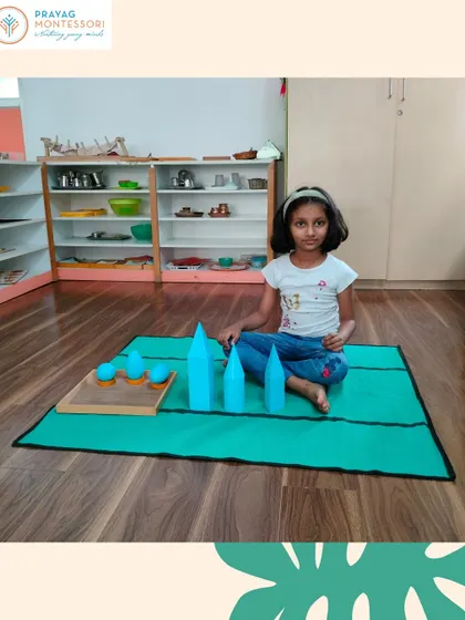 A student explores three-dimensional shapes with our Geometrical Solids. This hands-on material helps children internalize concepts of geometry and spatial awareness.