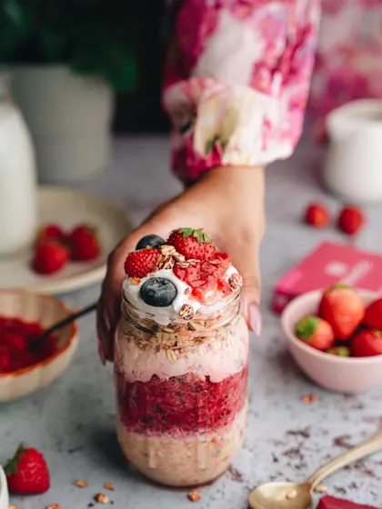 A lifestyle shot for Miheso, featuring a layered berry oat jar to create a feeling of a wholesome and delicious start to the day.
