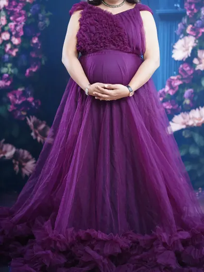 This wine-colored maternity gown features a unique textured bodice and a full, ruffled bottom. It also comes with detachable sleeves and a tail, so you can customize your look on the spot.