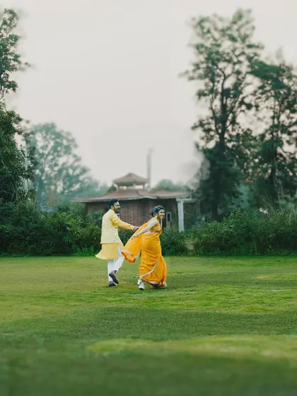 A playful, romantic moment in the gardens during a Haldi celebration. We find opportunities for beautiful couple shots amidst the day's events.