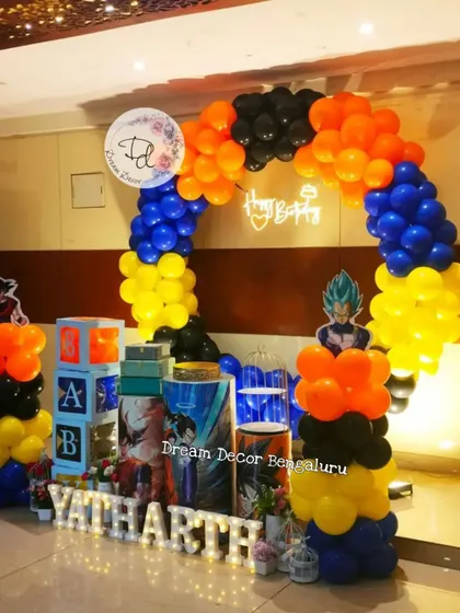 For the anime fans, we designed this action-packed Goku and Vegeta theme party. The decor uses the characters' signature colors of blue, orange, and yellow in the balloon arch, with a 'Happy Birthday' neon sign adding a cool glow.