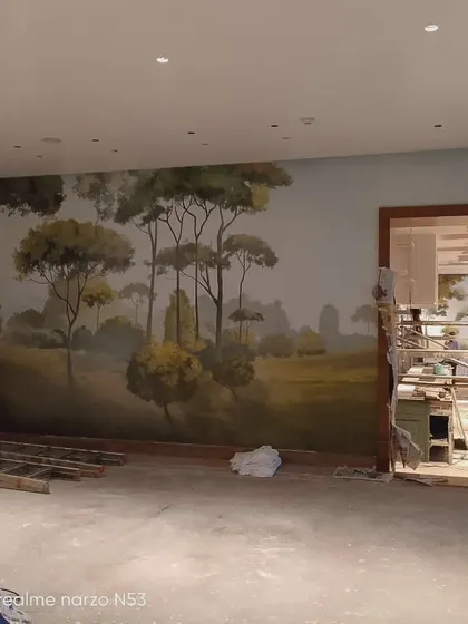 Another view of the hotel lobby mural installation in progress.