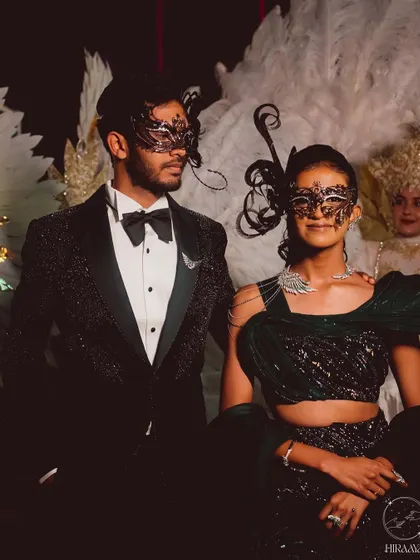 The couple in their full masquerade attire. The intricate masks added an element of mystery and romance to their grand entrance.