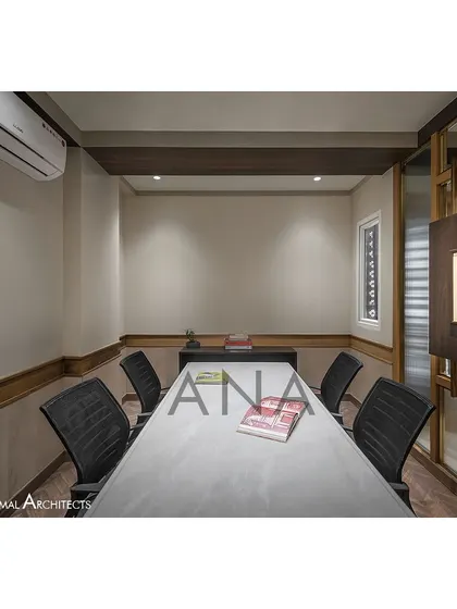 A side view of the conference room, highlighting the custom artwork display panel. This feature integrates the client's art collection directly into the office's architectural elements.