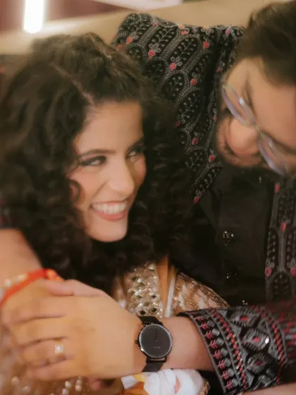 A close-up, candid moment of Shivani and Anubhav sharing a hug during their Sangeet. The soft focus and genuine smiles make this a truly heartwarming shot.