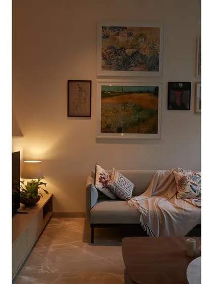 A comfortable sofa corner, perfect for reading or relaxing. The textiles and art add layers of personality and warmth.