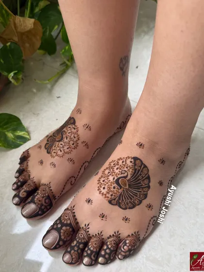 A modern and minimal foot design featuring a statement peacock on one foot and a smaller floral motif on the other.