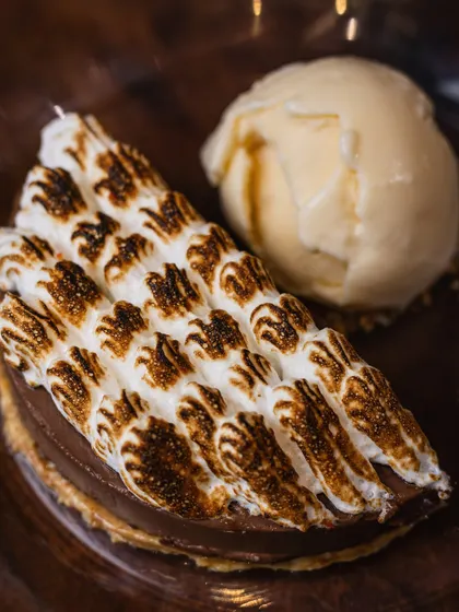 A close-up of my new Hazelnut Chocolate dessert with torched meringue, served alongside a scoop of ice cream. It's a new addition to the menu that I'm very excited to share.