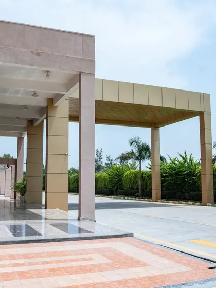 The entrance porch at Konark Academy provides a grand, sheltered drop-off point. The geometric floor pattern and clean lines of the pillars guide visitors toward the main entrance, establishing a clear and organized flow.