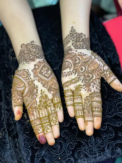 This design features a mix of geometric shapes and floral motifs. It's a great example of modern party mehendi.