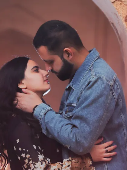 A close-up of their intimate embrace. This pre-wedding photo, taken in a rustic archway, feels incredibly romantic and timeless.