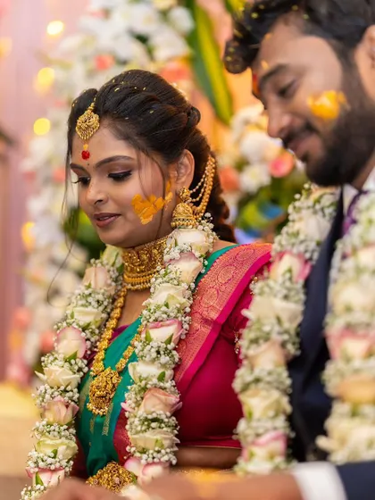 A candid moment from the wedding ceremony. This image captures the intricate details of the temple choker and long necklace during the rituals, showing how our jewellery becomes a part of your most cherished memories.