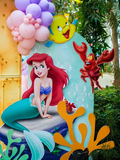 A close-up of the Little Mermaid side of the party decor, with Ariel, Flounder, and Sebastian cutouts.