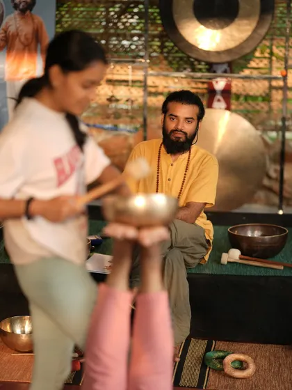 I watch as a student practices a singing bowl technique. My role is to guide and support you as you develop your skills and confidence as a healer.