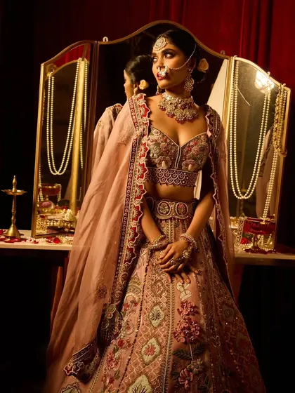 A full-length view of this campaign's bridal look. The hairstyle, makeup, and outfit create a picture of royal elegance.