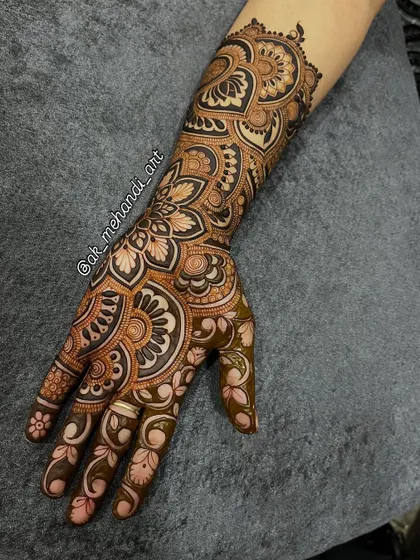 This full-hand design showcases a beautiful flow from the wrist to the fingertips, using a mix of floral and traditional Indian patterns.