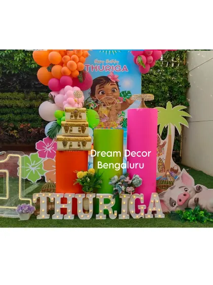 We brought the tropical vibes of Motunui to Bangalore for this Moana-themed first birthday. The decor features vibrant balloon colors, character cutouts of Moana and Pua, and tropical leaf details for an island adventure.