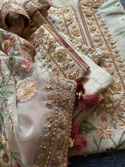 A macro shot of the sleeve cuff, showing the detailed Doriwork and embellishments.