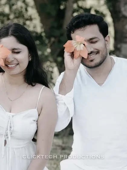 A playful and cute moment in Coorg, with the couple covering their eyes with flowers, capturing their fun and lighthearted connection.