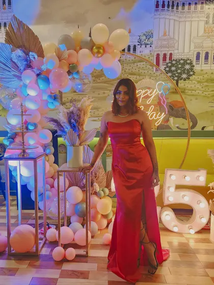 Another full-length shot of the red gown. This custom piece was designed to be both glamorous and comfortable for a night of celebrating.