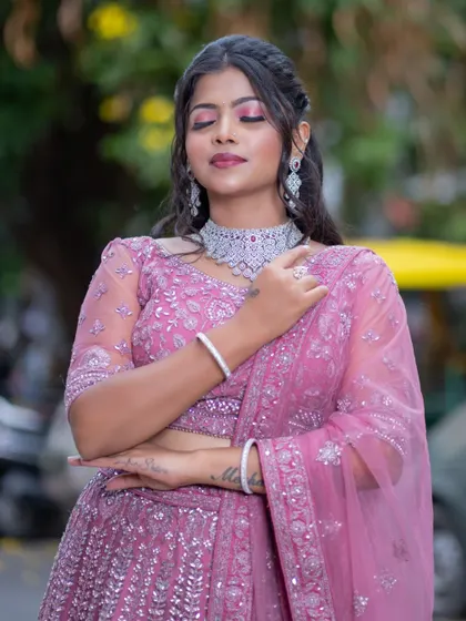 A three-quarter view of the pink lehenga, highlighting the delicate net dupatta and the intricate silver embroidery.