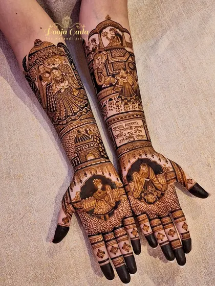 A full view of a heavy bridal design, featuring a doli scene, groom portrait, and intricate patterns covering the entire forearm.