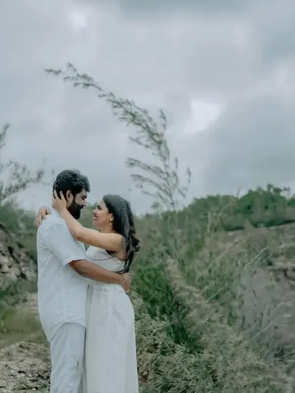 An embrace in a beautiful, natural landscape. This shot highlights the couple's connection while showcasing the scenic beauty of their chosen pre-wedding location.