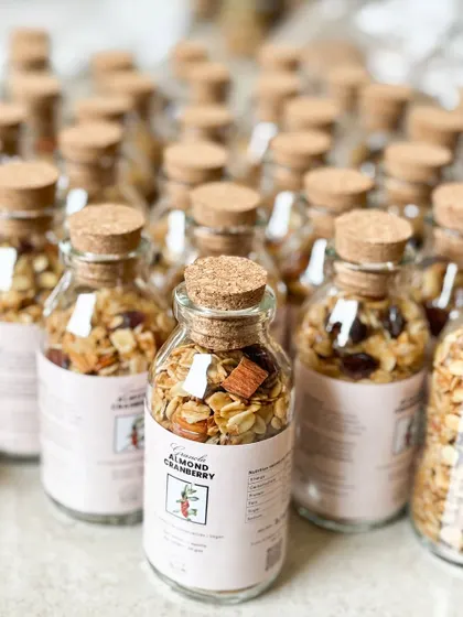 These granola bottles are a perfect healthy, vegan, and delicious favor for any occasion. We offer flavors like Almond Cranberry and Hazelnut Chocolate.