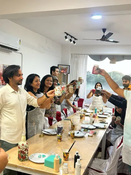 Cheers to creativity. This group is toasting to a successful and fun art session. It's a great way to celebrate and bond with friends.