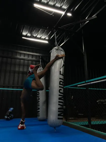 Another angle of the handstand on the punching bag, highlighting the balance and stability required for such an advanced movement. This is a testament to the high level of athleticism our members can achieve.