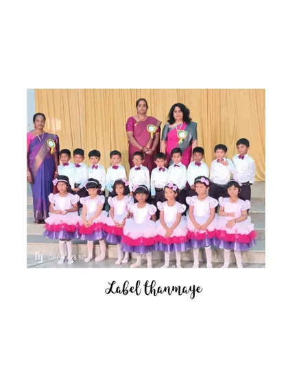 A group photo showcasing the coordinated pink and purple themed costumes for a school annual day performance.