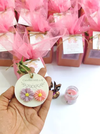 A rainbow-themed birthday gift box, including a mini jar candle, a mini wax sachet, and handmade chocolates.