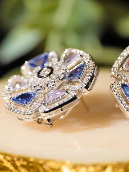 The captivating allure of midnight blue. These floral-inspired earrings are crafted with sapphires of different shades, creating a unique and beautiful design.