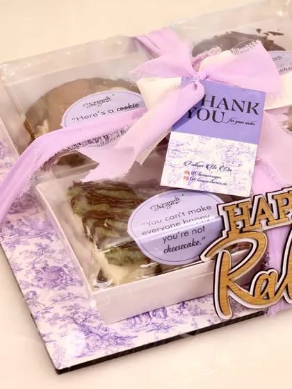 The final touches on our assorted Rakhi hamper, complete with a 'Thank You' card and personalized stickers.