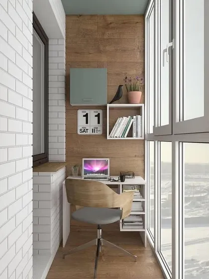 This workspace is perfect for a small, enclosed balcony. The design combines a simple desk with open shelving for books and decor, creating a functional and personalized office nook.