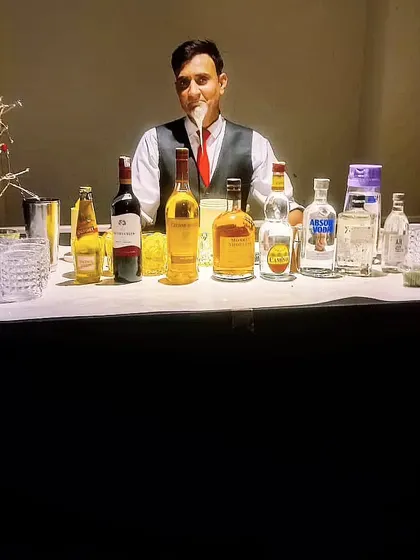 Our experienced bartender ready to serve at a house party. We can set up a full bar in any space, big or small.