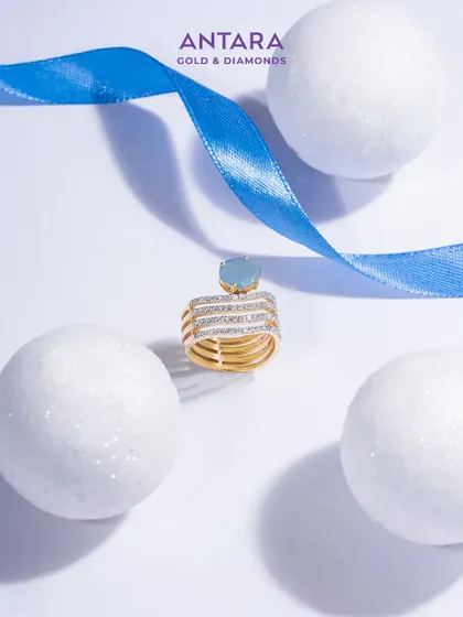 Diamond’s brilliance meets elegance. A serene aquamarine rests in a crown of gold and diamonds, a ring that tells a story of rare beauty.