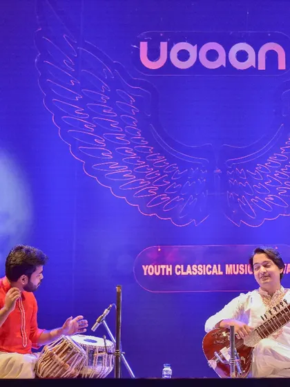 A candid moment of musical exchange on stage with sitar player Mehtab Ali Niazi. The smiles and gestures are as much a part of the performance as the notes themselves.