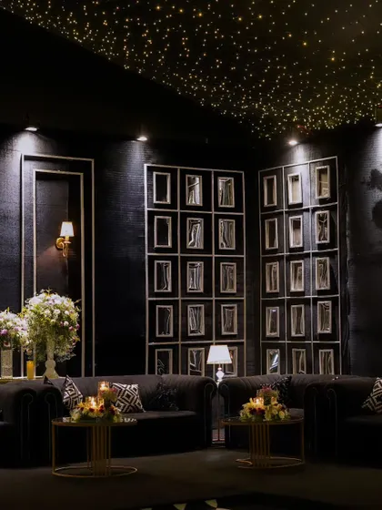 Another angle of the sophisticated lounge, showcasing the comfortable seating and beautiful floral centerpieces that invite guests to relax and mingle in style.